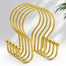 Set of gold hooks on a light gray background