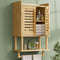 Bamboo wall-mounted cabinet with shelves against a green wall