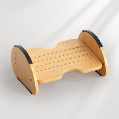 Wooden step stool with black accents on a light gray background