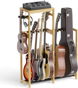 Bamboo wooden guitar stand holding various guitars and a mixer on a white background