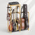 Guitar rack holding various guitars and a effects pedal on a white background