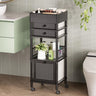 Black rolling cart with storage drawers and shelves in a bathroom setting.