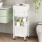 White storage tower with drawers and shelves in a bathroom setting.