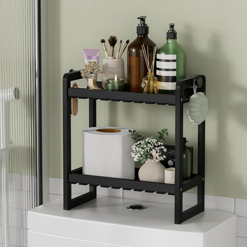 Black bathroom shelf with toiletries against a light green wall.