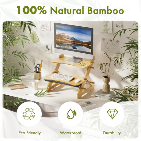 Bamboo desk setup with computer monitor, keyboard, and office supplies in a home office setting.