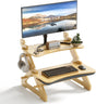 Wooden standing desk with monitor, keyboard, mouse, and headphones on a white background