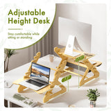 Adjustable height desk with laptop on a white desk setup