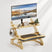 Wooden standing desk with monitor, keyboard, and accessories on a white background