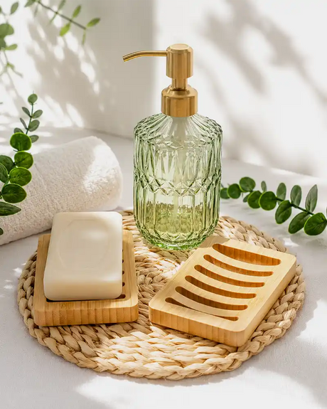 AmazerBath green glass soap dispenser, soap bar, and bamboo soap dish styled with greenery