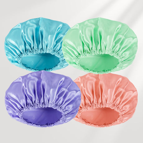 Four colorful shower caps in blue, green, purple, and pink on a white background.