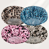 Four leopard print shower caps in different colors on a white background