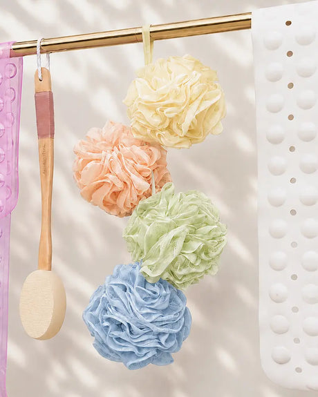 AmazerBath colorful bath loofahs and a long-handle body scrubber hanging against white tile