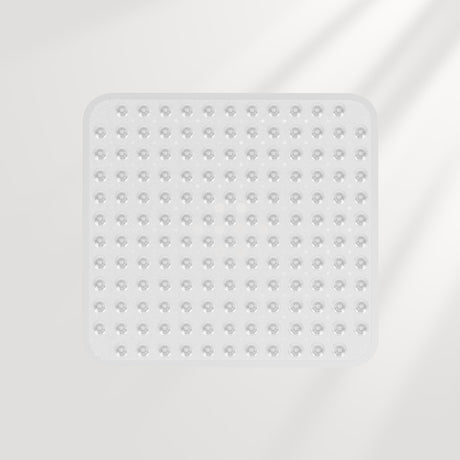 Clear square silicone mat with textured surface on a light gray background