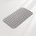 Gray bath mat with textured surface on a light gray background