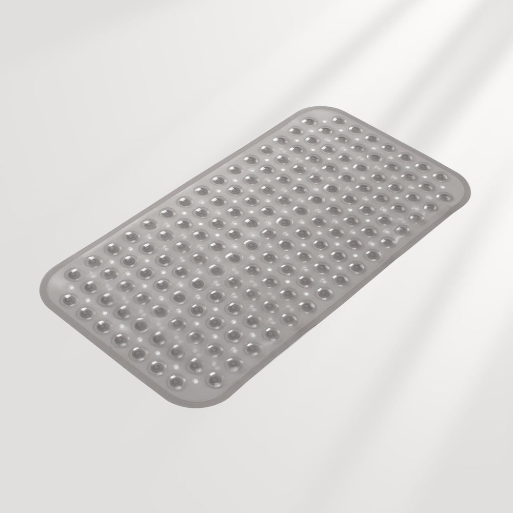 Gray bath mat with textured surface on a light gray background