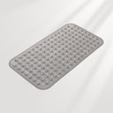 Gray bath mat with textured surface on a light gray background