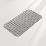Gray bath mat with textured surface on a light gray background