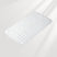 White bath mat with textured surface on a light gray background