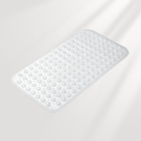 White bath mat with textured surface on a light gray background