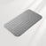 Gray textured bath mat on a light gray background