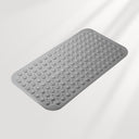 Gray textured bath mat on a light gray background