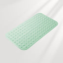 Mint green bath mat with textured surface on a light gray background