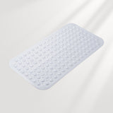 Silicone bath mat with textured surface on a light gray background