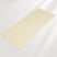Beige bath mat with textured surface on a light gray background