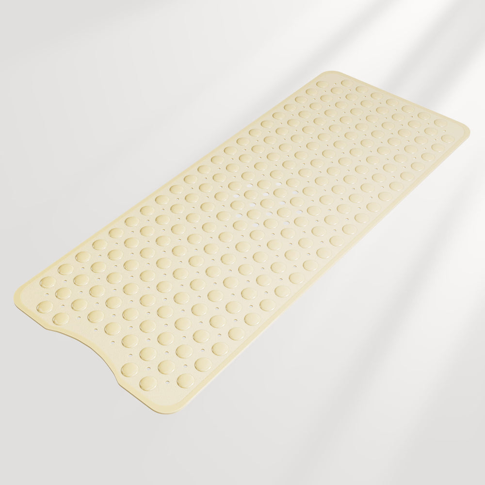 Beige bath mat with textured surface on a light gray background