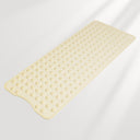 Beige bath mat with textured surface on a light gray background