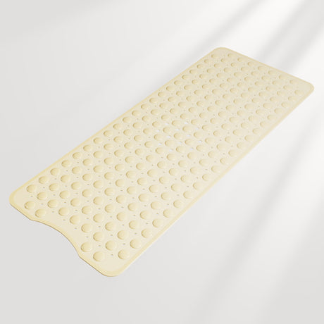 Beige bath mat with textured surface on a light gray background