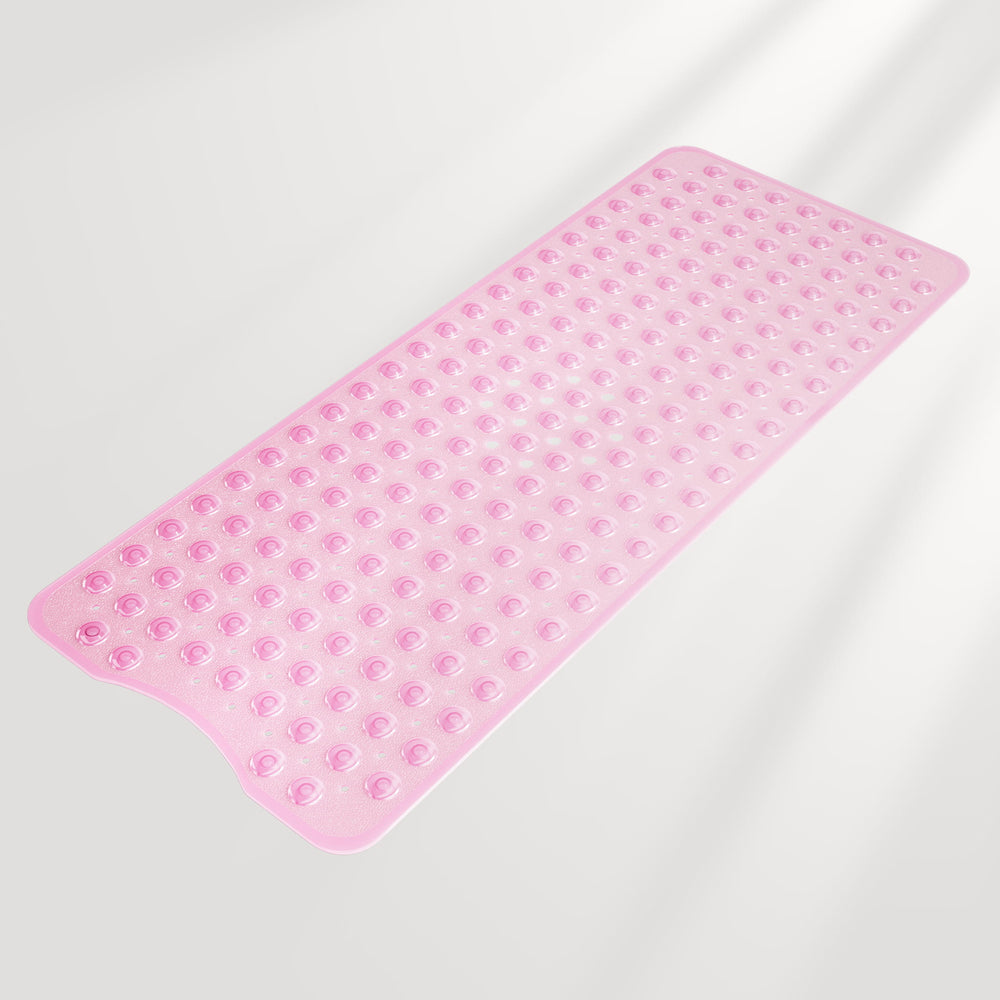 Pink bath mat with textured surface on a light gray background