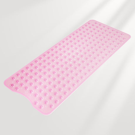 Pink bath mat with textured surface on a light gray background