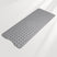 Gray bath mat with textured surface on a light gray background