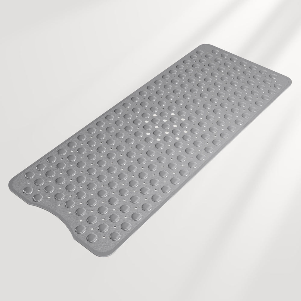 Gray bath mat with textured surface on a light gray background
