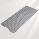 Gray bath mat with textured surface on a light gray background