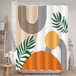 Shower curtain with geometric design featuring circles, leaves, and a sun in orange, green, and black.