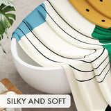 Striped curtain draped over a white bowl with a plant and soap in the background, labeled 'Silky and Soft'.