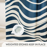 Blue and white striped shower curtain with a weighted stone on a beige surface