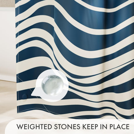 Blue and white striped shower curtain with a weighted stone on a beige surface