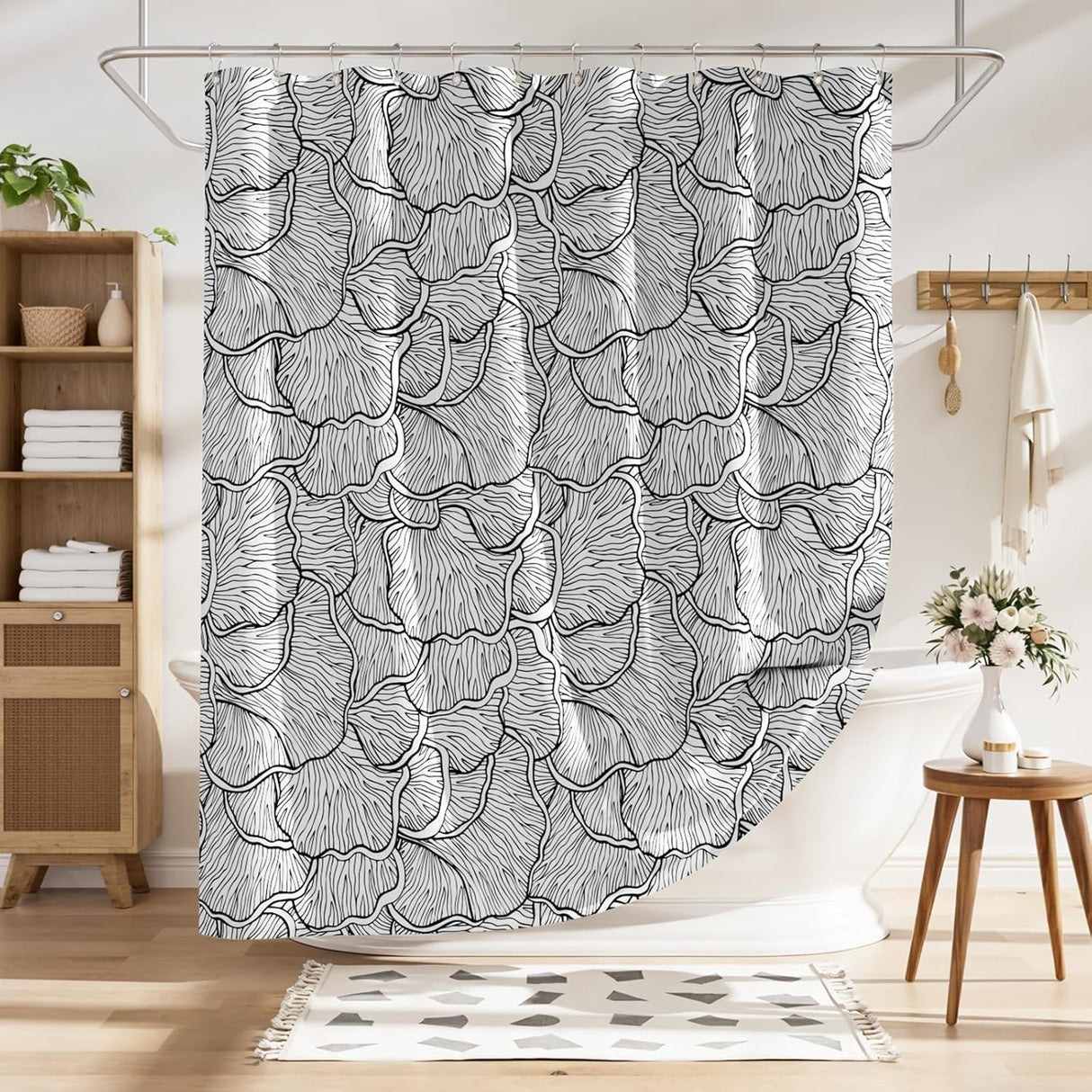 Shower curtain with black and white leaf pattern in a bathroom setting