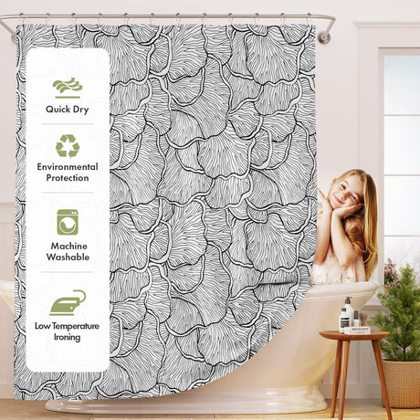 Shower curtain with black floral pattern and product features on the side, in a bathroom setting.