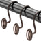 Curtain rod with bronze hooks on a white background