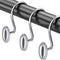 Silver curtain hooks on a black rod against a white background