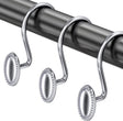 Silver curtain hooks on a black rod against a white background
