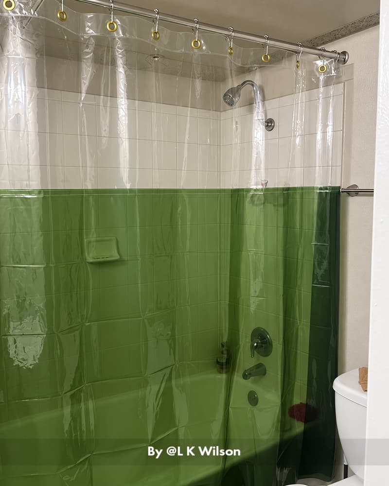 AmazerBath green color-block Sun EVA shower curtain liner enclosing a tiled bathtub with brass-colored hooks.