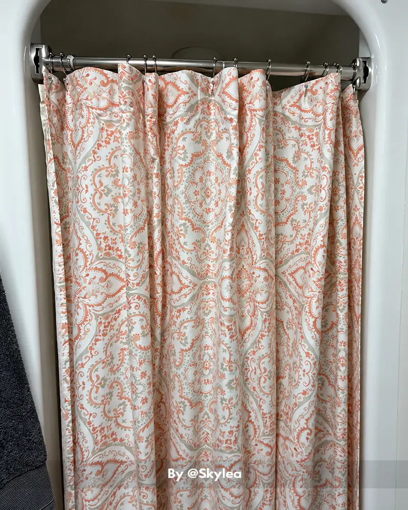 Customer bathroom photo showing a curved shower curtain rod installed above a tub, with the curved shape visible.