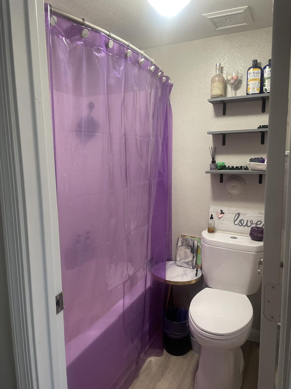 Purple translucent shower curtain in a bathroom