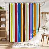 Colorful striped shower curtain in a bathroom setting with wooden furniture and decor.