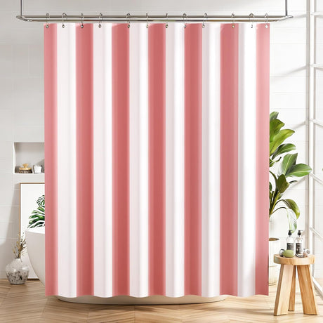 Striped pink and white shower curtain in a bathroom setting with plants and decor.